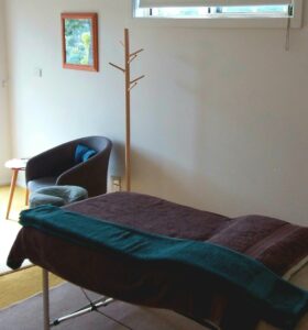 Massage table with towels and chair